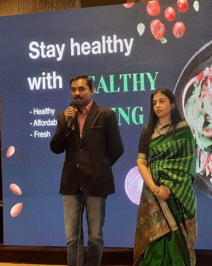 Dr. Arpitta Sephalli speaking on stage at a wellness event